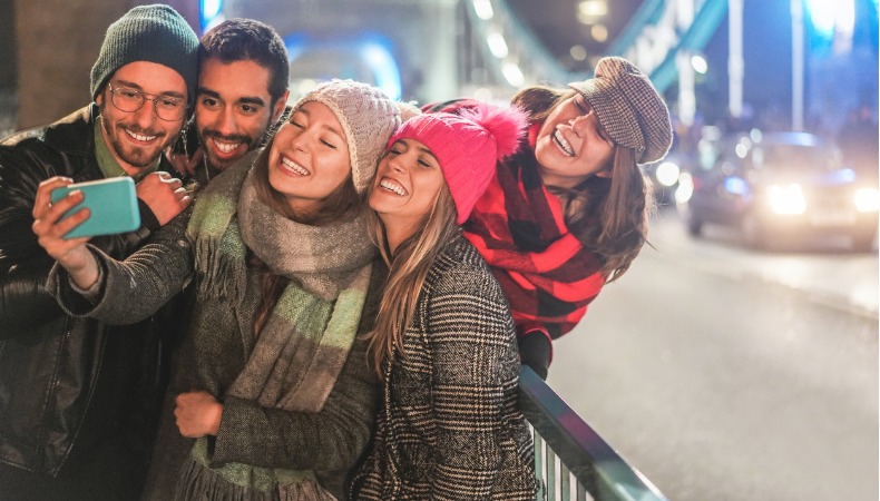 Happy Millennial friends: Posting organic content onto social networks like LinkedIn or Twitter.